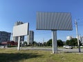 Blank white road billboard in city in summer sunny day. Street advertising poster, mock up, Glued paper mockup Royalty Free Stock Photo