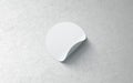 Blank white round adhesive sticker mockup on textured wall,