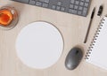 Blank and white, round computer mouse pad on the desk at home. Mousepad mockup. Copy space for your picture or text Royalty Free Stock Photo