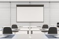 Blank white screen in front of rows of tables Royalty Free Stock Photo