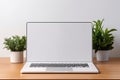 Blank white screen with laptop computer mockup isolated on office desk background Royalty Free Stock Photo