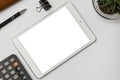 Blank white screen mockup.White office table with tablet pc computer,calculator,pen.Top view with copy space.Working business desk Royalty Free Stock Photo