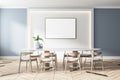 Blank white screen on white wall in light eco style dining room with modern white table and wooden chairs and parquet. Mock up Royalty Free Stock Photo