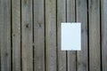 Blank white sheet of paper notice at the wooden fence. Advertising mockup Royalty Free Stock Photo