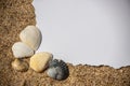 Blank white sheet of paper on white sand with seashells and stones. Message by the sea, romance, valentine's Royalty Free Stock Photo