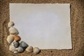 Blank white sheet of paper on white sand with seashells and stones. Message by the sea, romance, valentine's Royalty Free Stock Photo