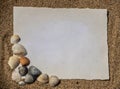 Blank white sheet of paper on white sand with seashells and stones. Message by the sea, romance, valentine's Royalty Free Stock Photo