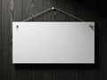 Blank white sign hanging on dark wooden wall with metal string Royalty Free Stock Photo
