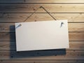 Blank white sign hanging on rustic wooden wall with blue string and small decorative elements Royalty Free Stock Photo