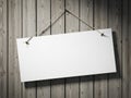 Blank white sign hanging on rustic wooden wall with string and nails Royalty Free Stock Photo