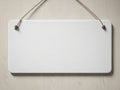 Blank white sign hanging on a wooden wall with a string Royalty Free Stock Photo
