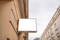 Blank sign outside a shop or restaurant with copy space in old city street. Blank signboard outdoors. Royalty Free Stock Photo