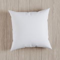 Blank white soft square pillow on a wooden floor, 3D render