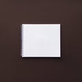 Blank white spiral notebook on brown surface. Mockup., Stationeries on blackboard Royalty Free Stock Photo