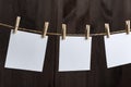 Blank white blank square paper cards with clothespins on rope. Place for your text. Copy space Royalty Free Stock Photo