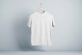 Blank white t-shirt round neck on hanger in the air with place for your brand name on abstract light background. 3D rendering, Royalty Free Stock Photo