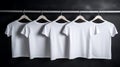 Blank white t-shirts set hanging on hangerâs mockup dark black background Royalty Free Stock Photo