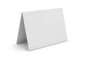 Blank white table tent card standing on a white surface ready for custom text or design Royalty Free Stock Photo