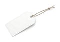 A blank white tag attached with a silver string on a white background Royalty Free Stock Photo