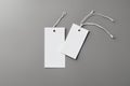 blank white tag on white background blank white paper tag with a string on a gray backgroundblank white tag on white background