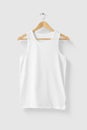 Blank White Tank Top Shirt mockup on wooden hanger isolated on light grey background front side view. Royalty Free Stock Photo