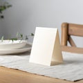 Blank White Tent Card on Wooden Table with Minimalist Setting Royalty Free Stock Photo