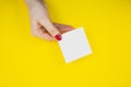 Blank white To Do List Sticker in woman hand. Close up of reminder note paper on the yellow background. Copy space. Minimalism, Royalty Free Stock Photo