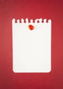 The Blank white torn paper note with push pin on red background Royalty Free Stock Photo