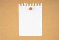 The Blank white torn paper note with wooden push pin on brown board background Royalty Free Stock Photo