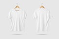 Blank White V-Neck Shirt mockup on wooden hanger isolated on light grey background front and rear side view. Royalty Free Stock Photo
