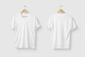 Blank White V-Neck T shirt mockup on wooden hanger isolated on light grey background front and rear side view. Royalty Free Stock Photo