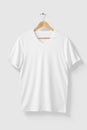 Blank White V-Neck T shirt mockup on wooden hanger isolated on light grey background front side view. Royalty Free Stock Photo