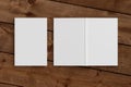 Blank white vertical closed and open and upside down book cover on wooden boards isolated with clipping path around cover. Royalty Free Stock Photo