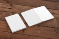 Blank white vertical closed and open and upside down book cover on wooden boards isolated with clipping path around cover. Royalty Free Stock Photo