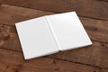 Blank white vertical open and upside down book cover on wooden boards isolated with clipping path around cover. Royalty Free Stock Photo