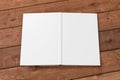 Blank white vertical open and upside down book cover on wooden boards isolated with clipping path around cover. Royalty Free Stock Photo