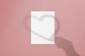Blank white vertical paper sheet 5x7 inches with hand and heart shadow overlay. Modern and stylish valentine greeting