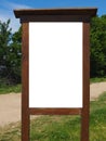 Blank white vertical rectangular pylon stand on forest dirt road mock up. Empty panel for advertisement, promotion