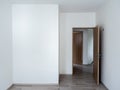 Blank white wall background in the empty room near the wooden opened door with copy space. Royalty Free Stock Photo