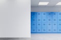 Blank white wall and blue lockers in a school hallway. 3D Rendering Royalty Free Stock Photo