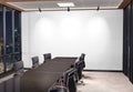 Blank white wall Mockup in dark modern office with windows and spotlights. Empty company meeting room 3D rendering Royalty Free Stock Photo