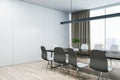 Blank wall with place for poster or banner in a modern meeting room with wooden office desk and chairs, mockup. 3D Rendering Royalty Free Stock Photo