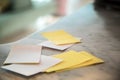 Blank white and yellow sheets of paper spread out on top of a flat surface, table. Selective focus Royalty Free Stock Photo