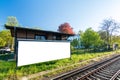 Blank wide screen poster on house wall next to the rails at the station Royalty Free Stock Photo