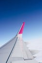 Blank wing of a flying plane against the bright blue sky Royalty Free Stock Photo