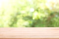 Blank wood table top with sun and blur green tree. Royalty Free Stock Photo