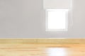 Blank wood table top view and blur window on grey wall from office with sunlight. Modern room for product display or design