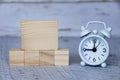 Blank wooden blocks and alarm clock with customizable space for ideas or text. Royalty Free Stock Photo