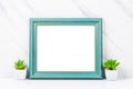 The Blank wooden blue vintage horizontal photo frame with plant pot on marble background, Save clipping path