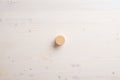 Blank wooden cut circle placed over a plain simple wooden background